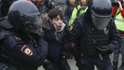 Police detain a man during a protest against the jailing of opposition leader Alexei Navalny in Moscow, Russia, Saturday, Jan. 23, 2021