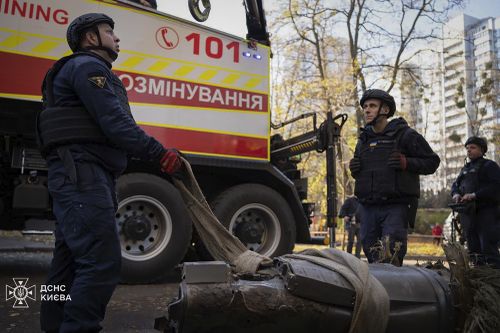 Emergency personnel remove part of a Russian missile that hit an apartment building during a massive rocket attack in Kiev, Ukraine, Sunday, Nov. 17, 2024. 