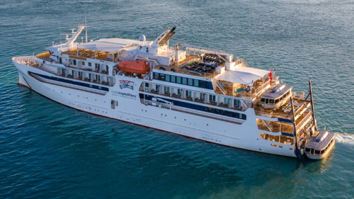 A passenger has been found dead on an exclusive island on the Great Barrier Reef after failing to board a cruise ship. 