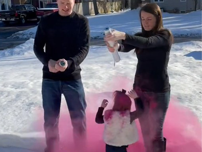 Little girl engulfed in pink smoke after a coloured smoke cannon was released the wrong way, onto her head.