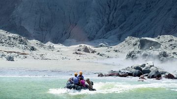 A photo provided by tourist Michael Schade shows rescuers leaving White Island following the eruption.