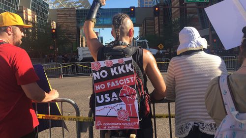 An anti-Trump protestor at the rally. (9NEWS/Lizzie Pearl)