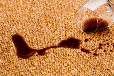 stained carpet with a spilled glass of red wine