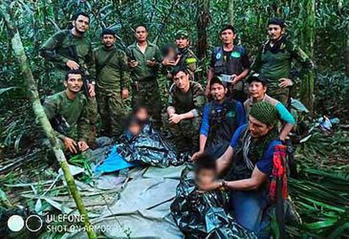Supplied image of Colombian children and rescuers in jungle (Government of Colombia)