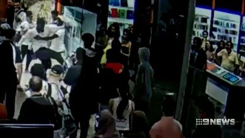 Footage shows an officer being kicked in the face at Highpoint Shopping Centre. (9NEWS)