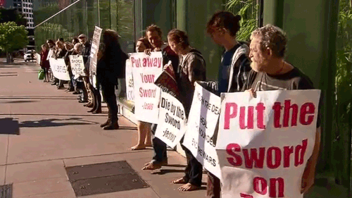 Supporters of the four men outside court opposed to the sword being placed alongside a crucifix. (9NEWS)