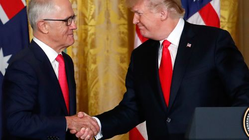 Prime Minister Malcolm Turnbull and President Donald Trump shake hands at the podium. (Image: AAP)
