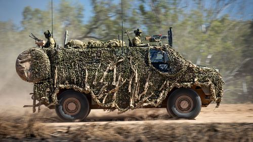 In this photo provided by the Australian Defence Force, an Australian Army Bushmaster armored vehicle moves off road during a training mission July 7, 2021, Townsville, Australia.