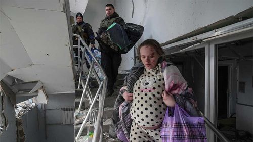 Mariana Vishegirskaya walks downstairs in of a maternity hospital damaged by shelling in Mariupol, Ukraine shortly before giving birth.