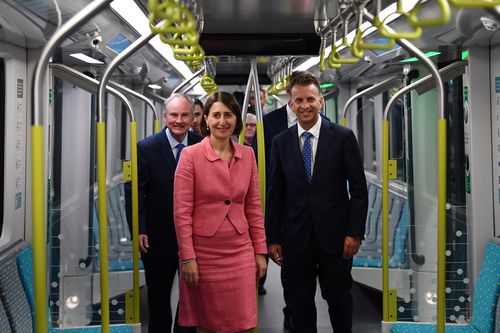 New South Wales Premier Gladys Berejiklian (centre), Minister for Transport Andrew Constance (right) and Member for Riverstone Kevin Conolly (left) take the first ride on a Sydney Metro train from Tallawong to Norwest in Sydney. (AAP Image/Dean Lewins) 