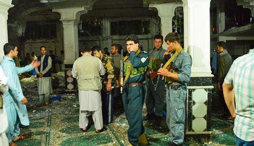 Security forces inspect the bomb site at the mosque. (Photo: AFP).