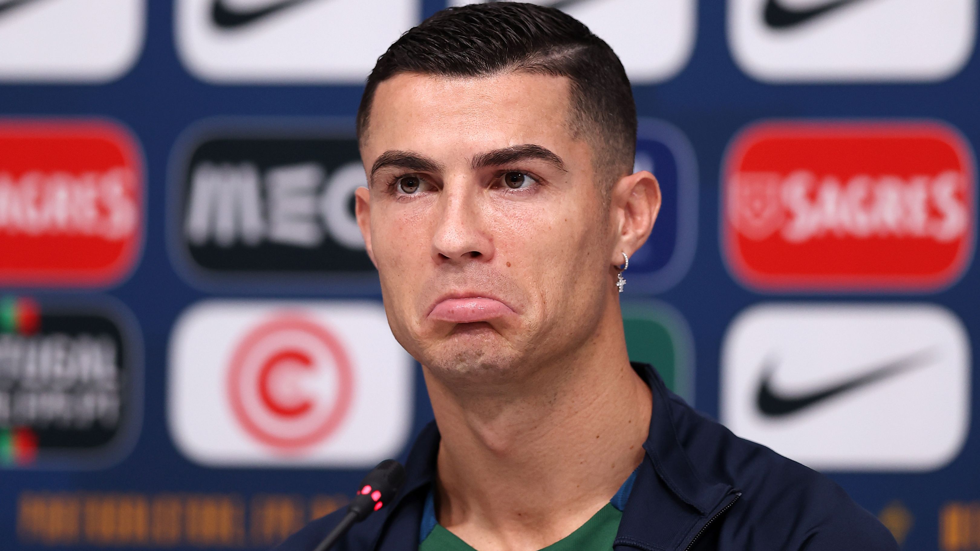 DOHA, QATAR - NOVEMBER 21: Cristiano Ronaldo of Portugal reacts during the Portugal Press Conference on November 21, 2022 in Doha, Qatar. (Photo by Christopher Lee/Getty Images )