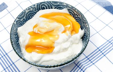 Greek yoghurt with honey on a blue and white tablecloth