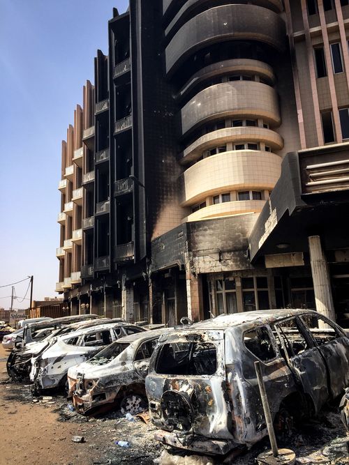 Bombed car wrecks and damage outside the Cappuccino cafe in Ouagadougou, following a terror attack in Burkina Faso