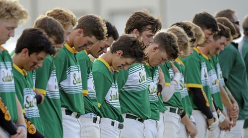 Santa Fe baseballers at a game in Deer Park, Texas, have a minute's silence for the victims. Picture: AP