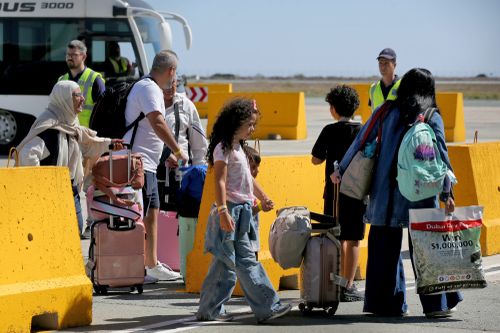 Australian nationals evacuated from Lebanon arrive at Larnaca International Airport on October 5, 2024 in Larnaca, Cyprus.  