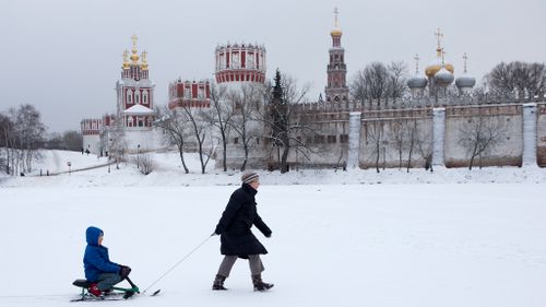 A woman and her child in front of the Novodevichy (New Maiden) convent.