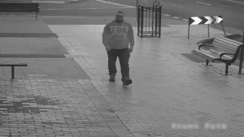 The man is seen strolling down an empty street before he approaches the van. (Victoria Police)
