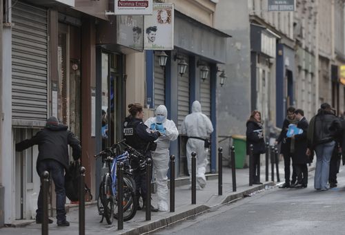 Police investigate at the scene where a shooting took place in Paris, Friday, Dec. 23, 2022. 