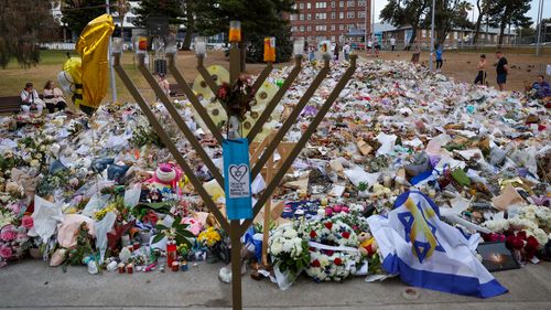 SYDNEY, AUSTRALIA - DECEMBER 21: General view of the memorial at Bondi Pavilion on December 21, 2025 in Sydney, Australia. Life slowly returned to normal at Bondi Beach, with people from all walks of life still paying respects and tributes as raw grief and funerals gave way to quiet commemorations. Police say at least 16 people, including one suspected gunman, were killed and more than 40 others injured when two attackers opened fire near a Hanukkah celebration at the world-famous Bondi Beach, i