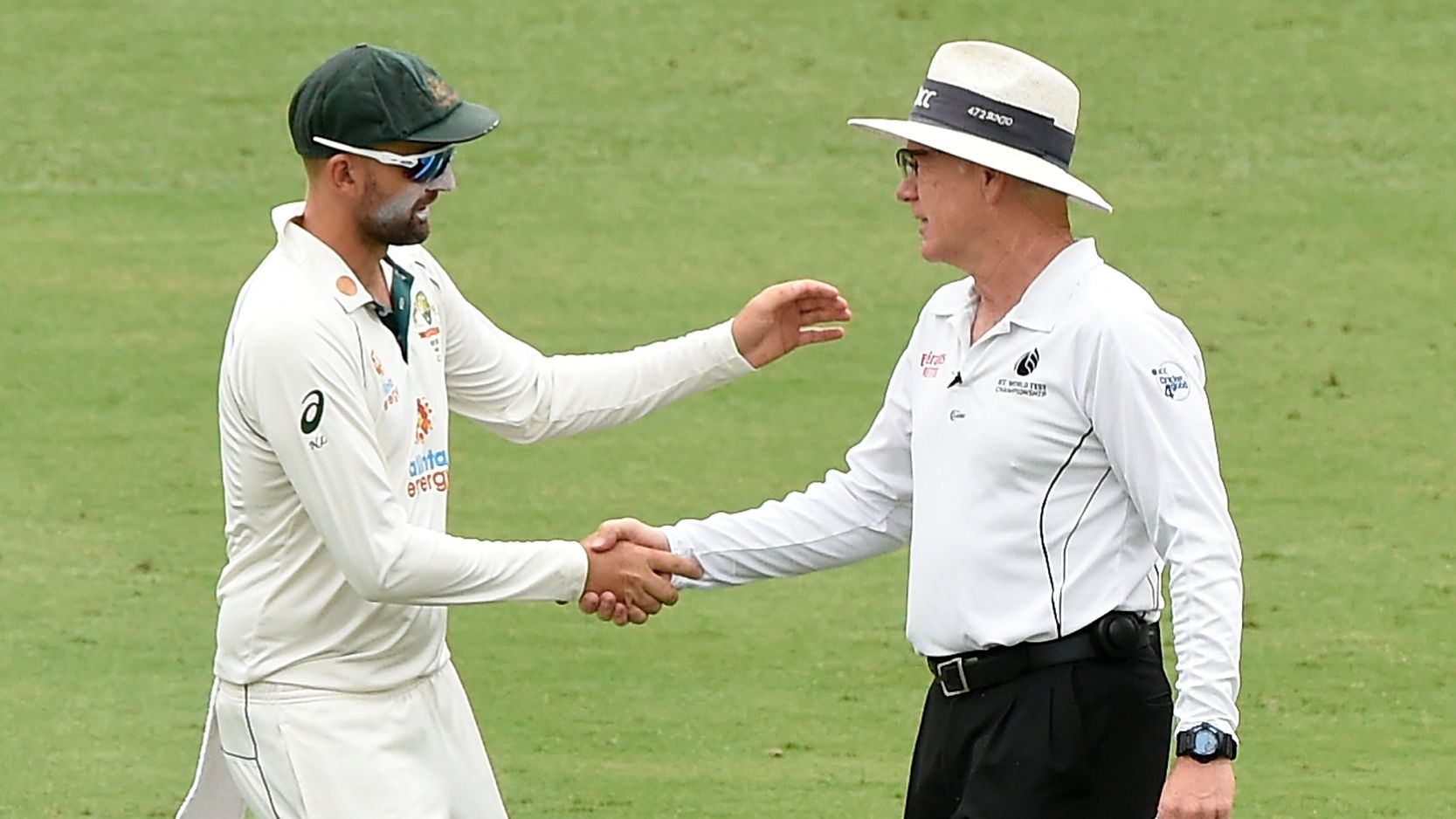Nathan Lyon of Australia shakes hands with umpire Bruce Oxenford.