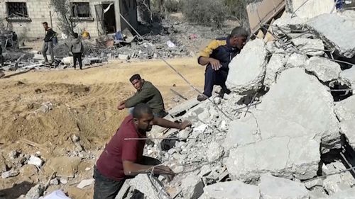 Palestinians sift through the rubble of a building destroyed by Israeli airstrikes in the city of Khan Younis, southern Gaza Strip, Friday, Oct. 25, 2024. (AP Photo)