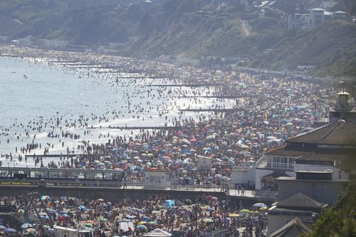 People are seen on Bourenmouth beach on the hottest day of the year.