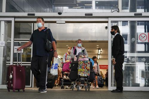 Passengers arrive at Gatwick Airport, in London, Monday, Aug. 2, 2021.
