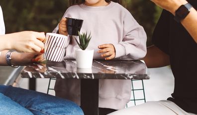 Child at cafe with couple