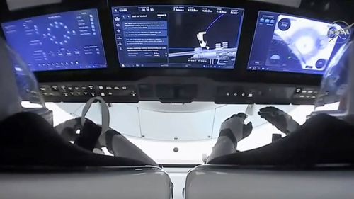 In this image from video provided by NASA, astronauts in the SpaceX Dragon capsule prepare for undocking from the International Space Station.