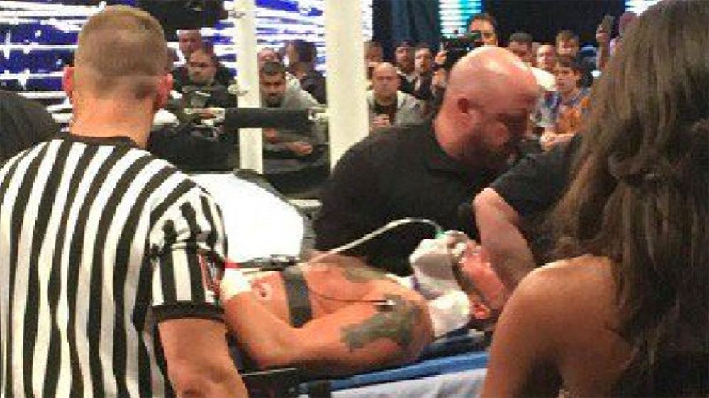 WWE wrestler Amore leaves match on a stretcher