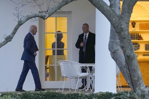 President Joe Biden, left, walks to the Oval Office on the South Lawn of the White House in Washington, Wednesday, Jan. 11, 2023, after returning from Walter Reed National Military Medical Center where first lady Jill Biden had surgery to remove skin cancer 