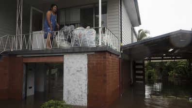 A Lansvale resident is trapped in her home as dangerous floodwaters surround her in Sydney's south-west.  