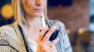 Woman drinking wine alone