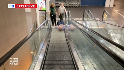 Woman trapped in escalator robbed while she waited to be freed