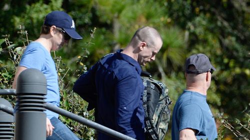 Bowe Bergdah (center), demoted to private from sergeant, is escorted from the Ft. Bragg military courthouse on November 3. (Getty)