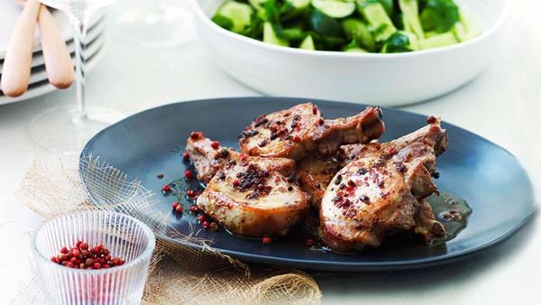 Pork cutlets with pink peppercorns and cucumber salad