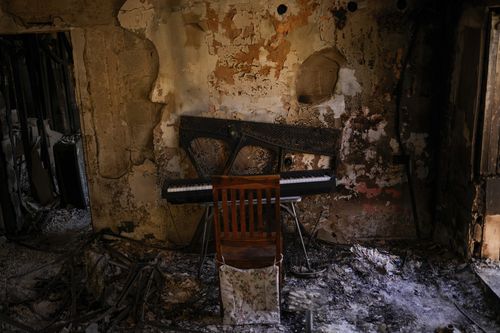 Destroyed furniture and charred walls are seen in a home that came under attack during a massive Hamas invasion into Kibbutz Nir Oz, Israel, Thursday, Oct. 19, 2023.