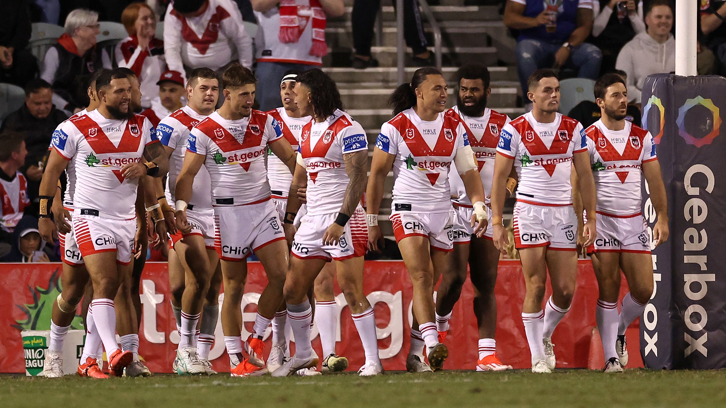 The Dragons celebrate a try against the Warriors.