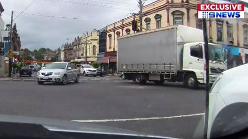 Dashboard camera footage from a nearby car shows the truck rolling backwards into oncoming traffic. (9NEWS)