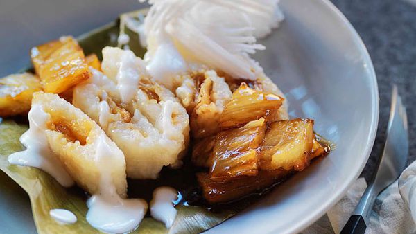 White sticky rice parcels with coconut and pineapple