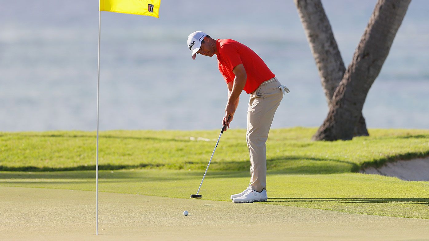 Adam Scott putting with the flagstick