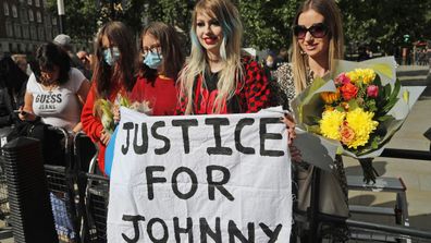 US Actor Johnny Depp supporters wait for the actor to arrive, outside the High Court in London, Tuesday, July 28, 2020.