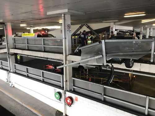 The car's front wheels were left hanging over the edge of the third-storey carpark. (9NEWS)