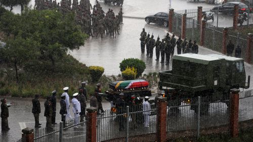 The coffin of Winnie Madikizela-Mandela is carried out of the official state funeral at Orlando stadium in the rain in Soweto. (EPA)