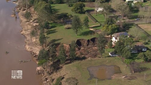 A farm north of Sydney that was underwater just days ago is now crumbling into an enormous sinkhole.