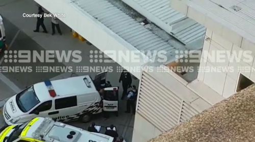 Vision obtained by 9NEWS shows the gunman being taken into the back of a police van. Picture: 9NEWS