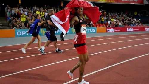 Michelle-Lee Ahye celebrates winning gold in the 100m. (AAP)