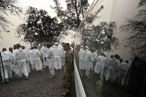 Members of the California Army National Guard prepare to search a property for human remains at the Camp fire.