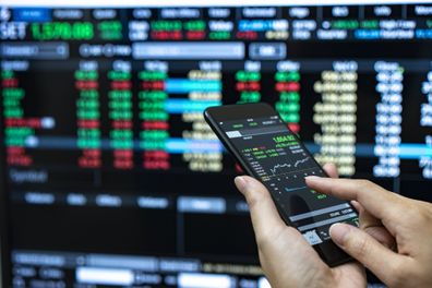 Person checking stock market investments on phone